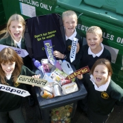 Children with recyclable material labels