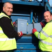 Smiling waste collection team from West Devon emptying food waste caddies into a waste collection vehicle