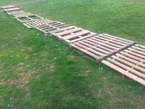 a pathway made of pallets across grass at Whipton barton loose parts play