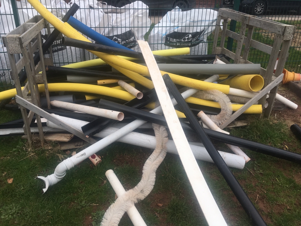 Stack of plastic tubing for loose parts play at whipton Barton Junior School