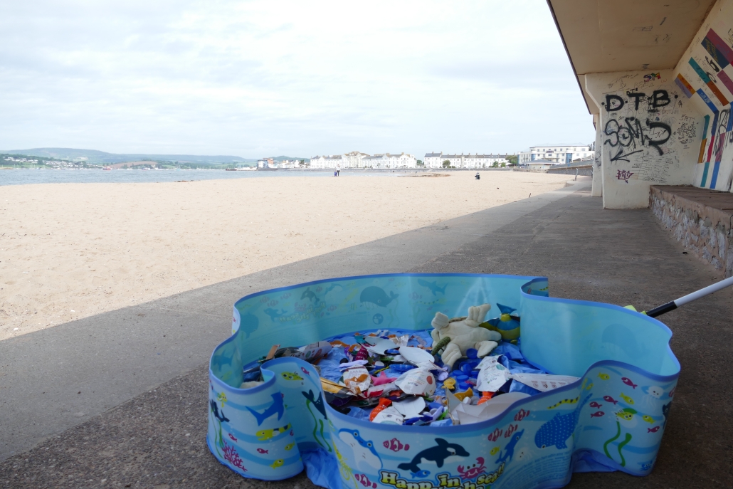 Image of children's paddling pool with fake fish inside on a beach