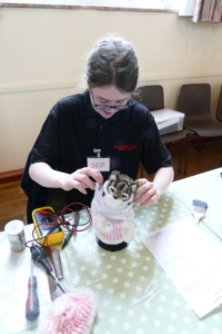 Seb at a repair cafe. Repairing a mechanical cat