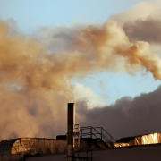 Picture of chimneys with yellow coloured smoke emerging