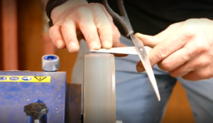 Scissors being sharped on a machine at a repair cafe