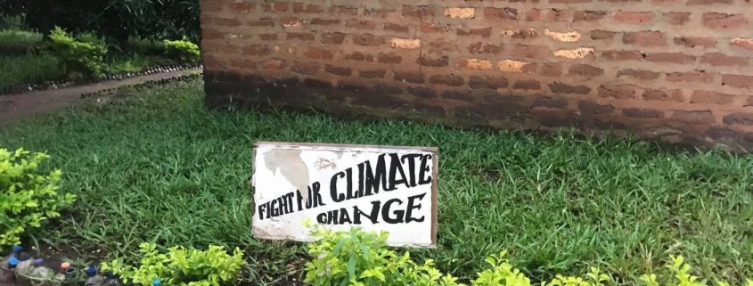 a sign saying Fight for Climate Change in a school garden in Tanzania