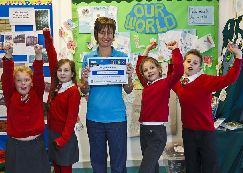 School children cheering with Waste Educator Sally holding up a certificate
