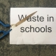 Scissors cutting into writing: Cutting Waste in Schools