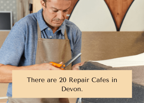 Photo of a man holding scissors and fabric with the text: There are 20 repair cafes in Devon.