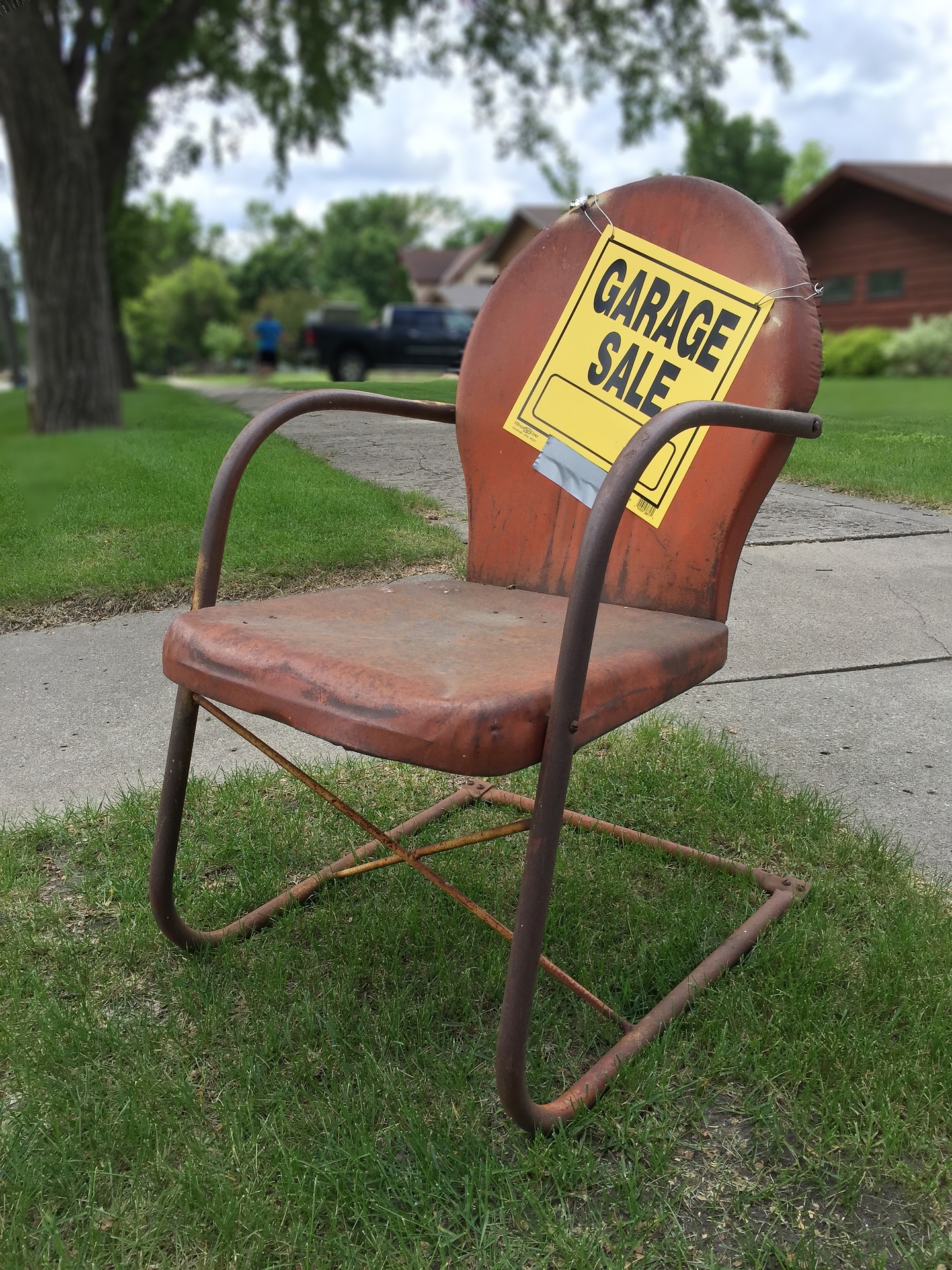 old chair displaying a garage sale sign