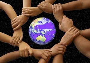 Picture of hands joined around a globe
