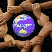 Picture of hands joined around a globe