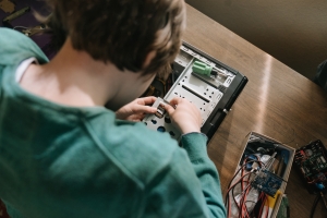 Children making or fixing an electronic device