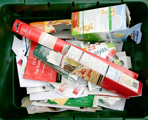 Card and paper in a green recycling box