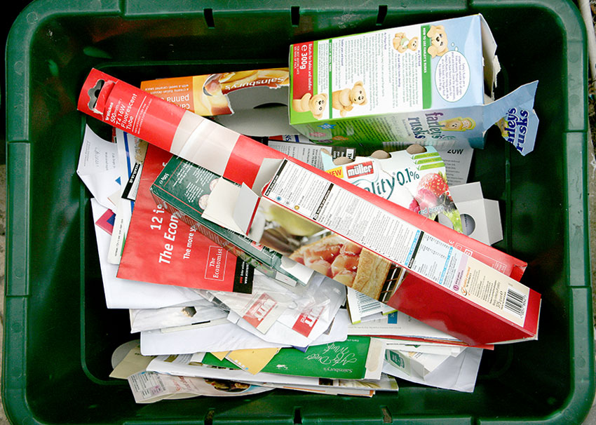 Card and paper in a green recycling box