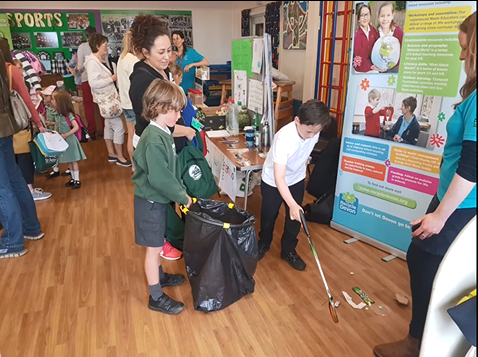 picture of school pupils at St Peters Primary in Budleigh enjoying a litter picking game with the Devon waste education team