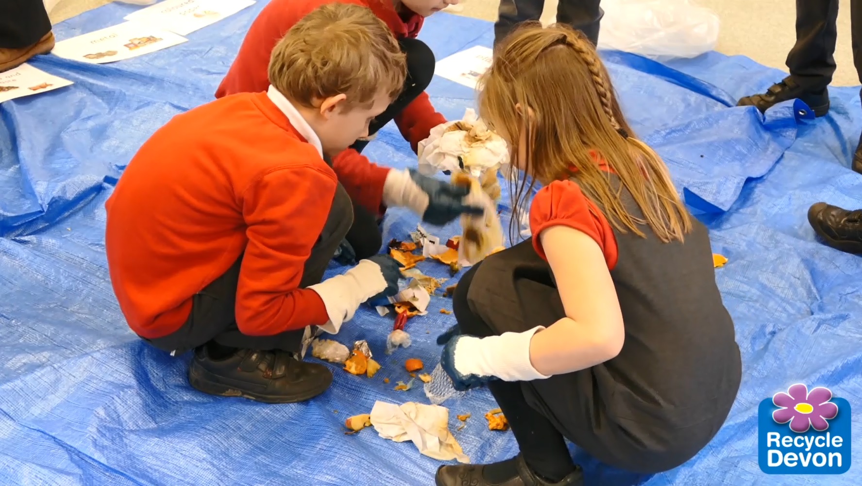 Children carrying out a waste audit by sorting school waste into different piles