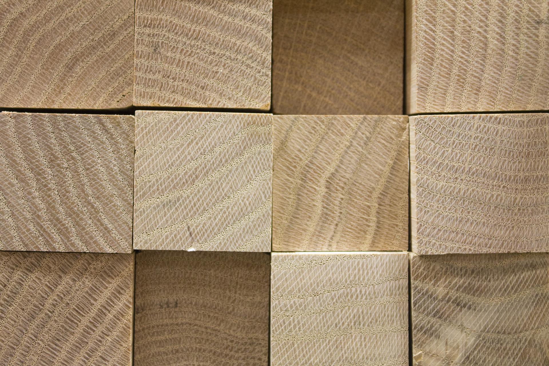 a picture of blocks of wood arranged in a neat pile, showing the square ends of the different pieces of wood